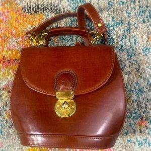 Vintage leather purse with ornate horse decoration at clasp